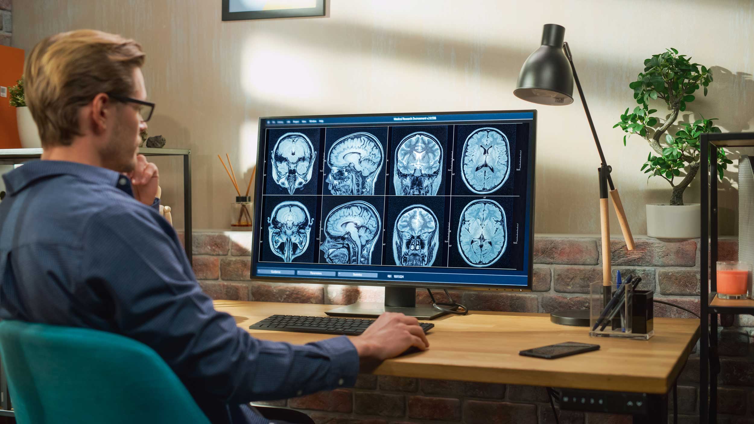 A person sitting at a desk looking at a computer screen