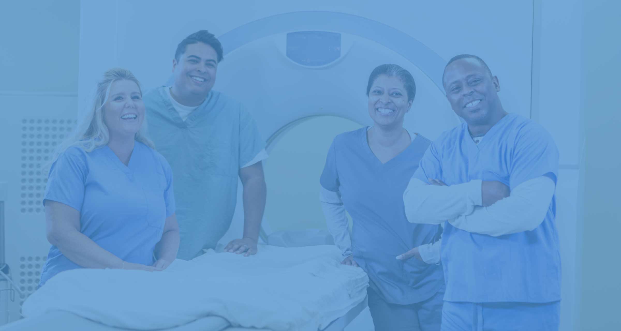 Technicians standing in front of MRI equipment