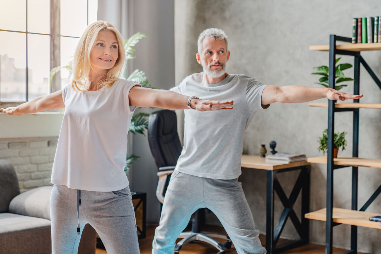 Man and woman practicing yoga